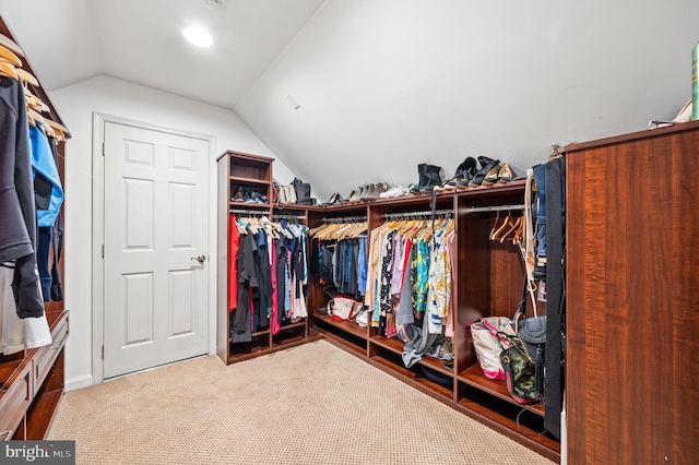 spacious closet with carpet and vaulted ceiling