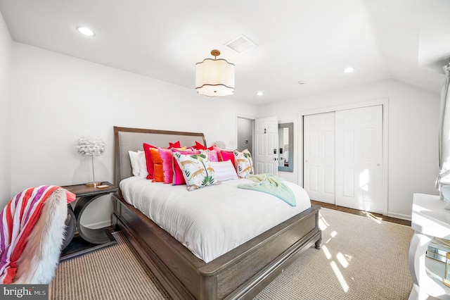 bedroom with recessed lighting, visible vents, a closet, and vaulted ceiling