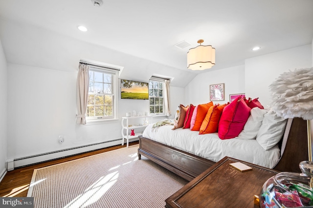 bedroom featuring visible vents, vaulted ceiling, baseboard heating, recessed lighting, and wood finished floors