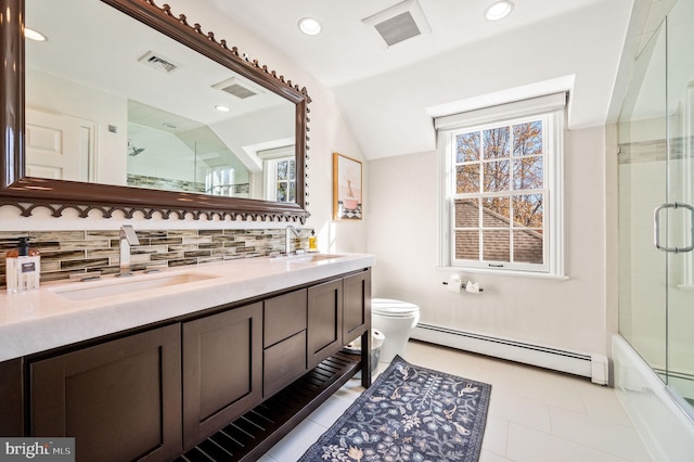 full bathroom featuring a sink, a baseboard heating unit, and visible vents