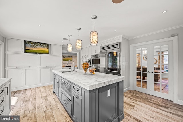 kitchen with a sink, gray cabinets, white cabinets, stainless steel appliances, and open shelves