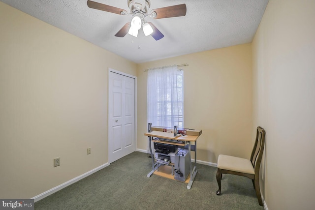 office area featuring dark colored carpet, baseboards, a textured ceiling, and a ceiling fan