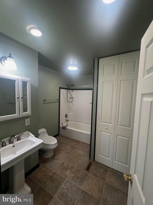 full bathroom with toilet, shower / bathing tub combination, and a sink