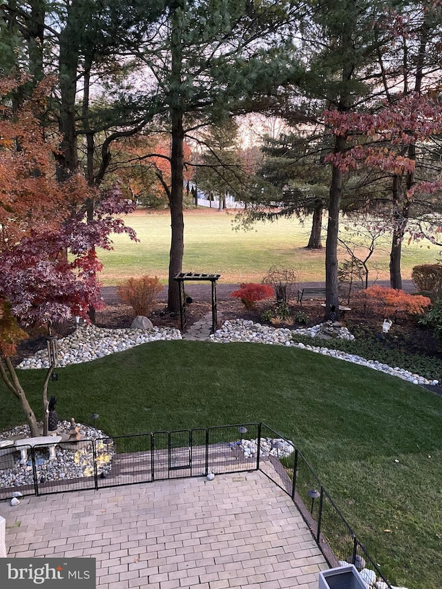 surrounding community featuring a lawn and fence