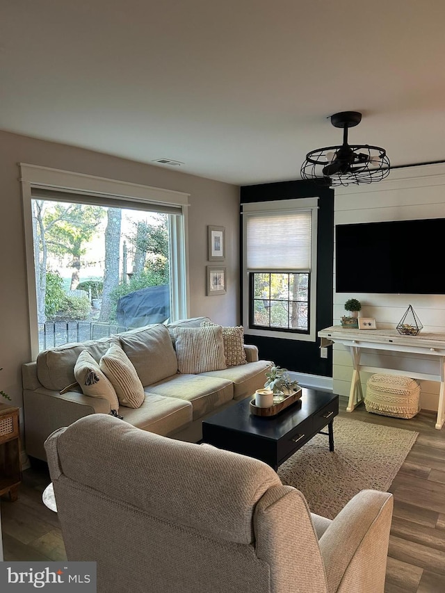 living room featuring wood finished floors and visible vents