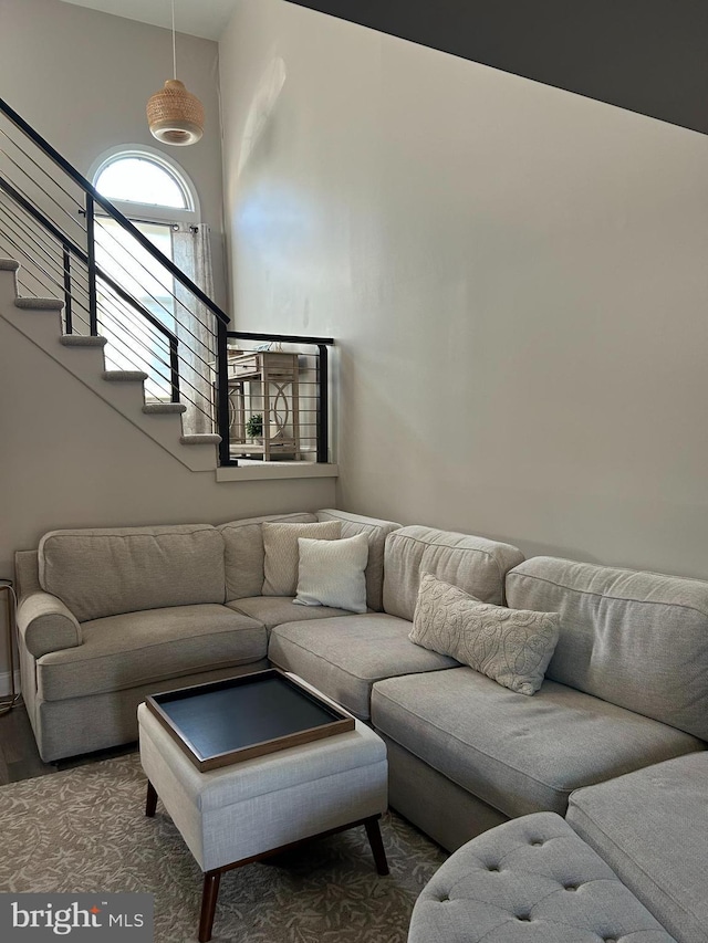 living area with stairs and wood finished floors