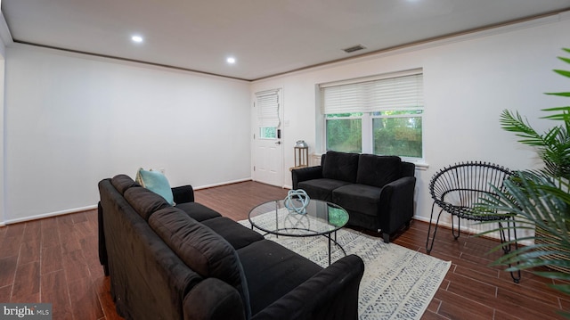 living area featuring wood finished floors, baseboards, visible vents, recessed lighting, and ornamental molding