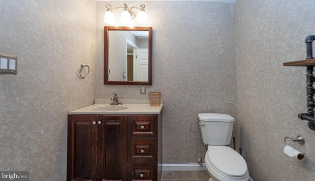 bathroom featuring tile patterned floors, toilet, and vanity