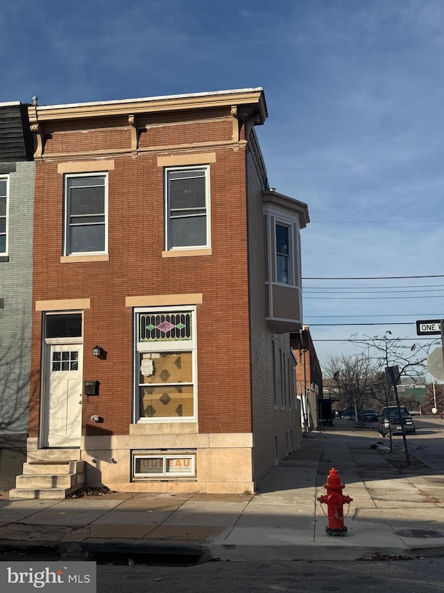 view of front facade featuring brick siding and entry steps