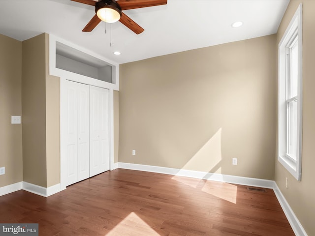 unfurnished bedroom with a closet, baseboards, and wood finished floors