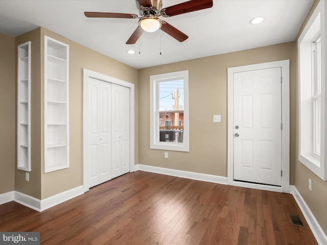 foyer with recessed lighting, visible vents, baseboards, and dark wood finished floors