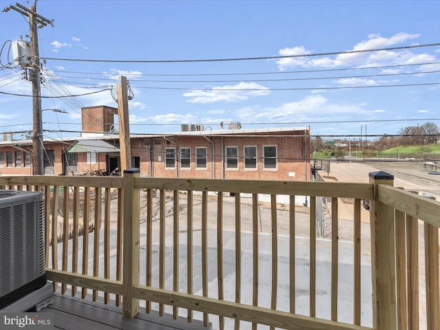 wooden terrace featuring cooling unit