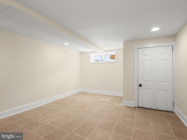 basement featuring light tile patterned flooring, recessed lighting, and baseboards