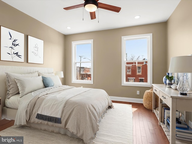 bedroom with recessed lighting, wood finished floors, baseboards, and ceiling fan