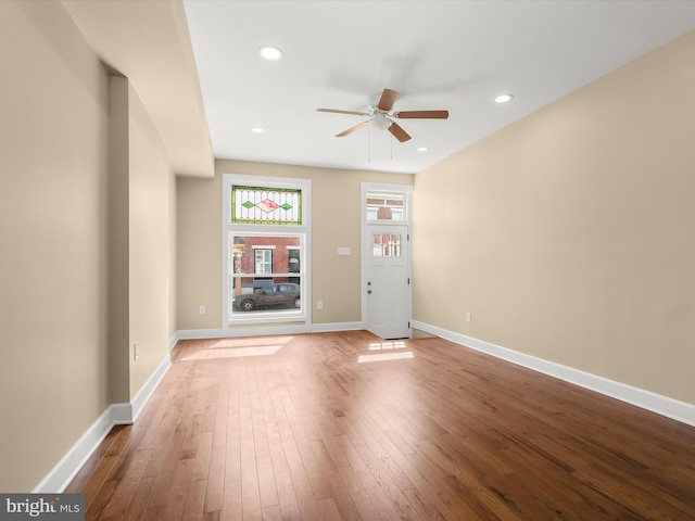 unfurnished living room with recessed lighting, a ceiling fan, baseboards, and wood-type flooring