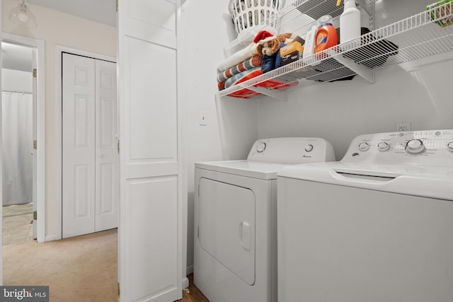 laundry area with light carpet, laundry area, and washer and clothes dryer