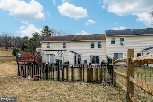 back of house featuring a yard and a fenced backyard