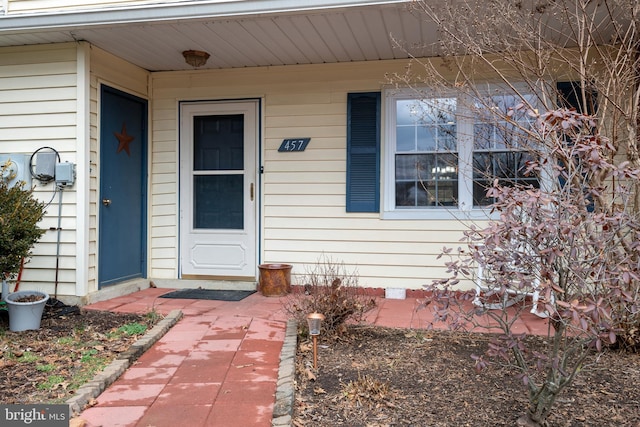 doorway to property with crawl space and a porch