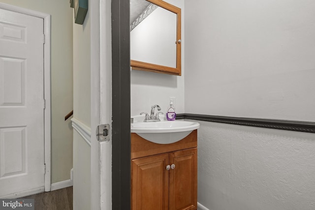 bathroom with vanity and wood finished floors