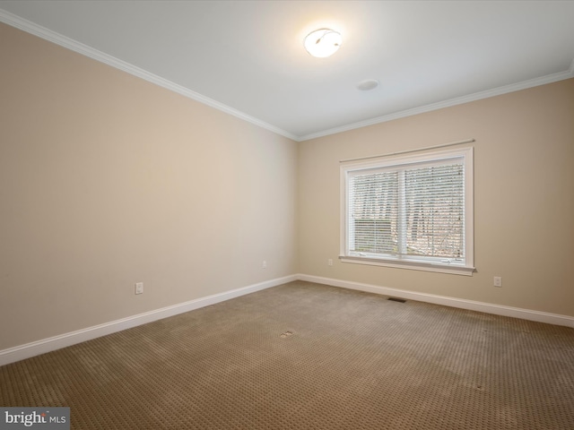 unfurnished room featuring carpet flooring, baseboards, visible vents, and crown molding