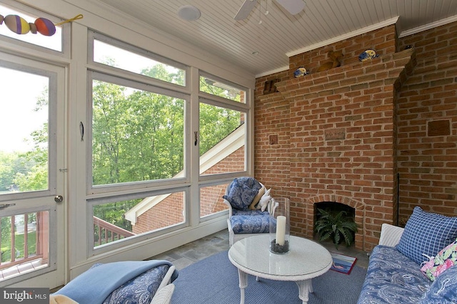 sunroom featuring a wealth of natural light and a ceiling fan