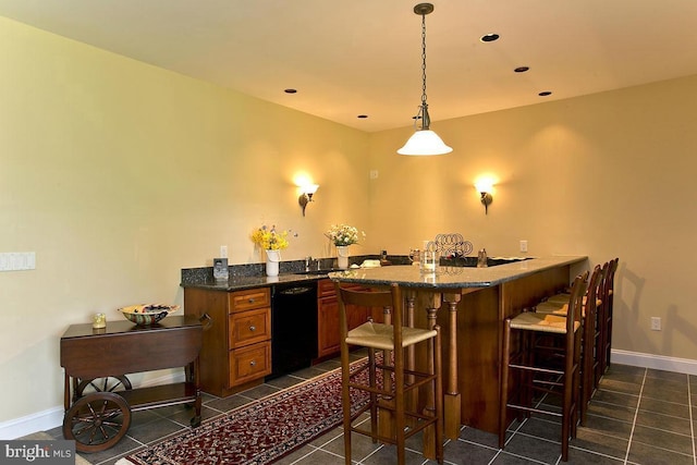 bar featuring baseboards, dishwasher, pendant lighting, recessed lighting, and dark tile patterned flooring