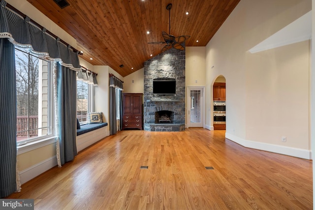 unfurnished living room featuring wood ceiling, a fireplace, light wood-style floors, high vaulted ceiling, and a ceiling fan