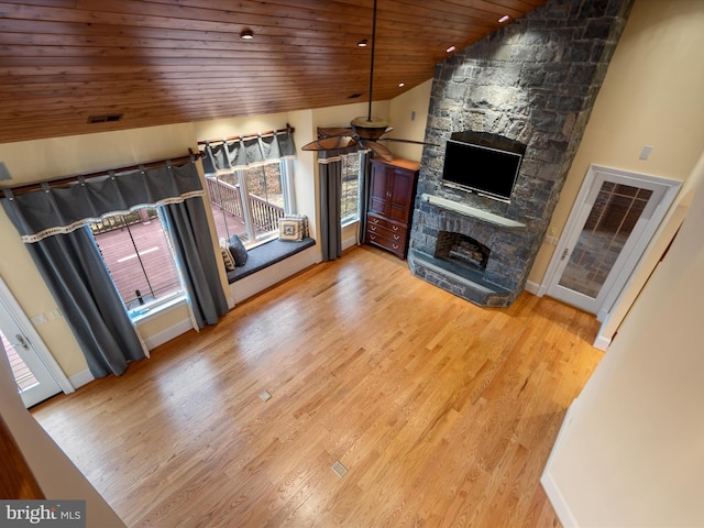 unfurnished living room with ceiling fan, light wood-style flooring, a fireplace, wooden ceiling, and high vaulted ceiling