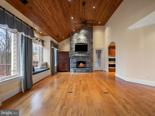 unfurnished living room featuring a ceiling fan, wood ceiling, a fireplace, and light wood-style flooring