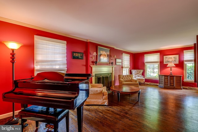 living area with wood finished floors, crown molding, a fireplace, and baseboards