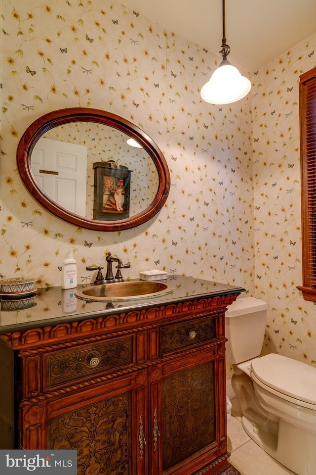 bathroom with tile patterned floors, toilet, vanity, and wallpapered walls