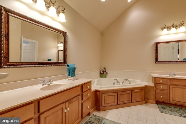 bathroom with tile patterned flooring, a garden tub, vaulted ceiling, two vanities, and a sink