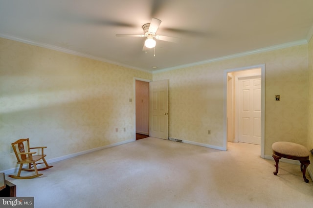 empty room with ornamental molding, baseboards, ceiling fan, and carpet floors