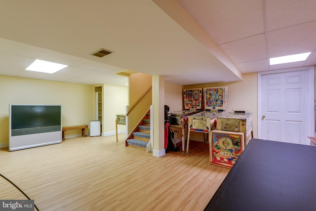 playroom featuring a drop ceiling, visible vents, baseboards, and wood finished floors