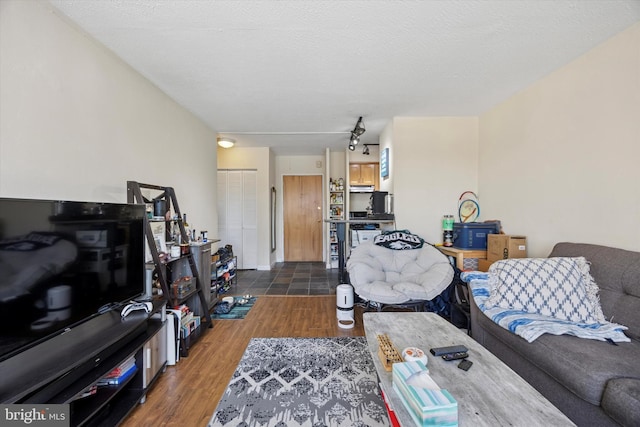 living area featuring a textured ceiling and wood finished floors