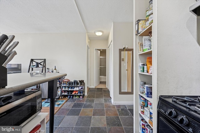 office space with stone finish floor, baseboards, and a textured ceiling