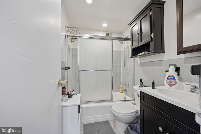 full bathroom featuring toilet, recessed lighting, tile walls, bath / shower combo with glass door, and vanity