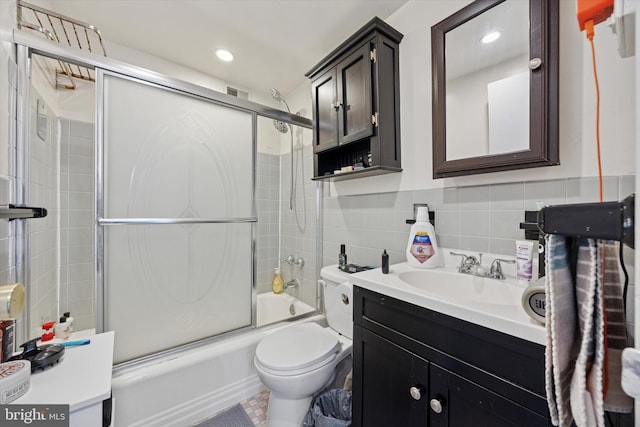 full bathroom with toilet, recessed lighting, tile walls, enclosed tub / shower combo, and vanity