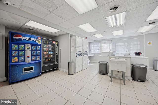 interior space with light tile patterned floors, visible vents, independent washer and dryer, and stacked washer / drying machine