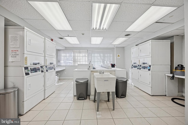 shared laundry area with light tile patterned floors, separate washer and dryer, and stacked washer and clothes dryer