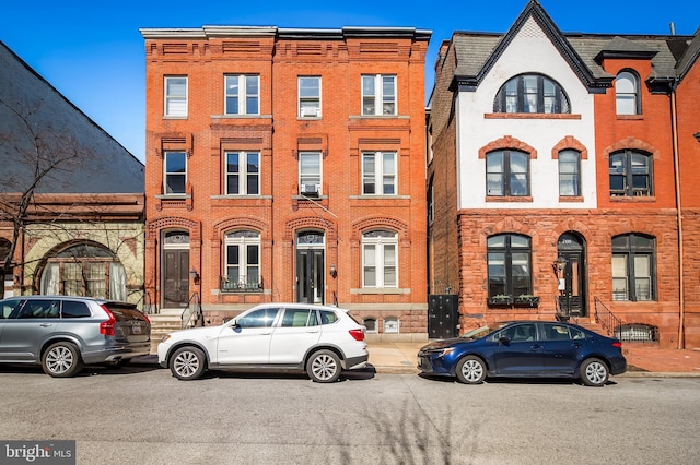 townhome / multi-family property featuring brick siding