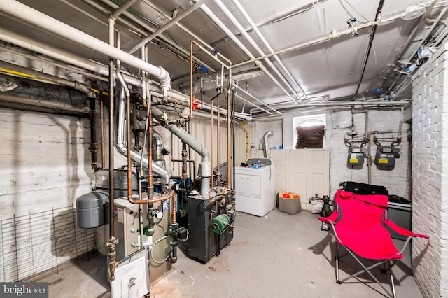 unfinished basement featuring washer / clothes dryer and a heating unit