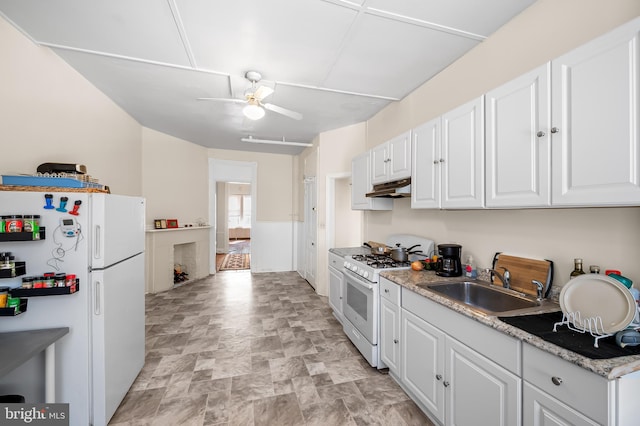 kitchen featuring white appliances, white cabinetry, ceiling fan, and a sink