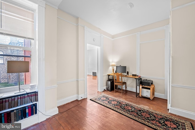 office area with baseboards, a healthy amount of sunlight, and hardwood / wood-style floors