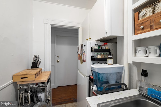 kitchen featuring butcher block counters and white cabinetry