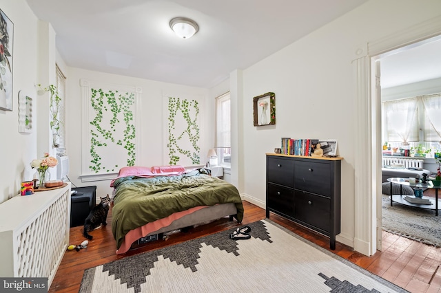 bedroom with wood finished floors and baseboards