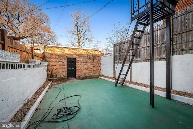 view of patio featuring an outbuilding and a fenced backyard