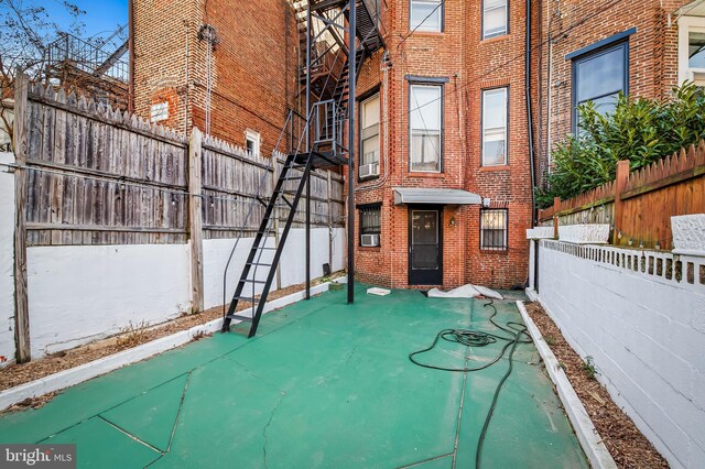 view of patio / terrace with cooling unit and fence