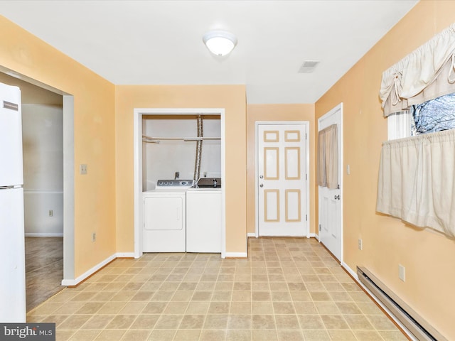 laundry area featuring visible vents, a baseboard heating unit, baseboards, laundry area, and washing machine and clothes dryer