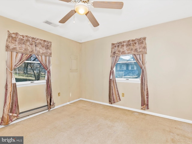 spare room featuring carpet flooring, plenty of natural light, baseboards, and visible vents